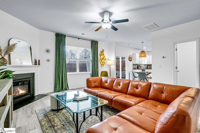 living room with hardwood / wood-style flooring and ceiling fan