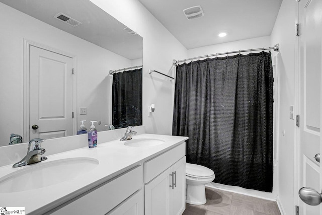 full bathroom with shower / tub combo with curtain, vanity, and toilet