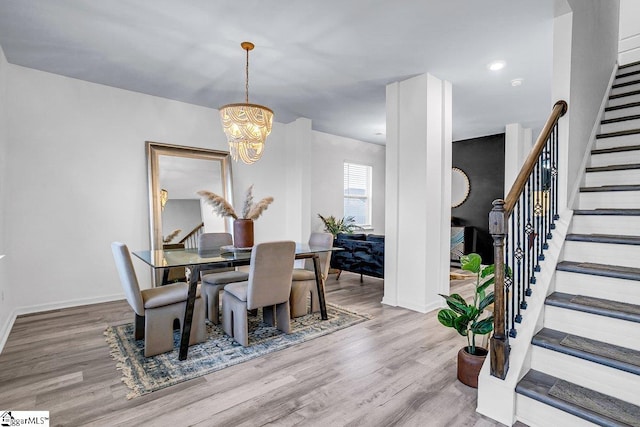 dining area featuring a chandelier and light hardwood / wood-style floors