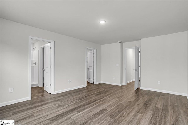 interior space featuring dark wood-type flooring and ensuite bath