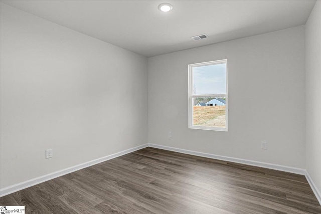 empty room with dark hardwood / wood-style floors