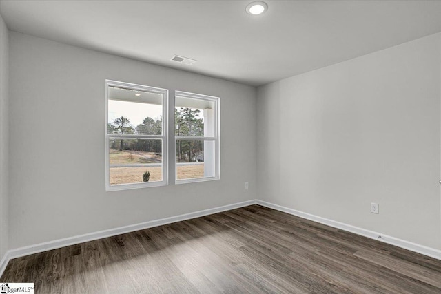 empty room featuring dark wood-type flooring