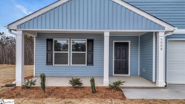 view of exterior entry with a porch