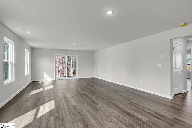 unfurnished living room featuring dark wood-type flooring