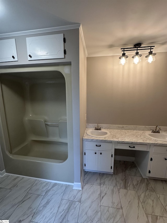 bathroom featuring crown molding, a washtub, and vanity