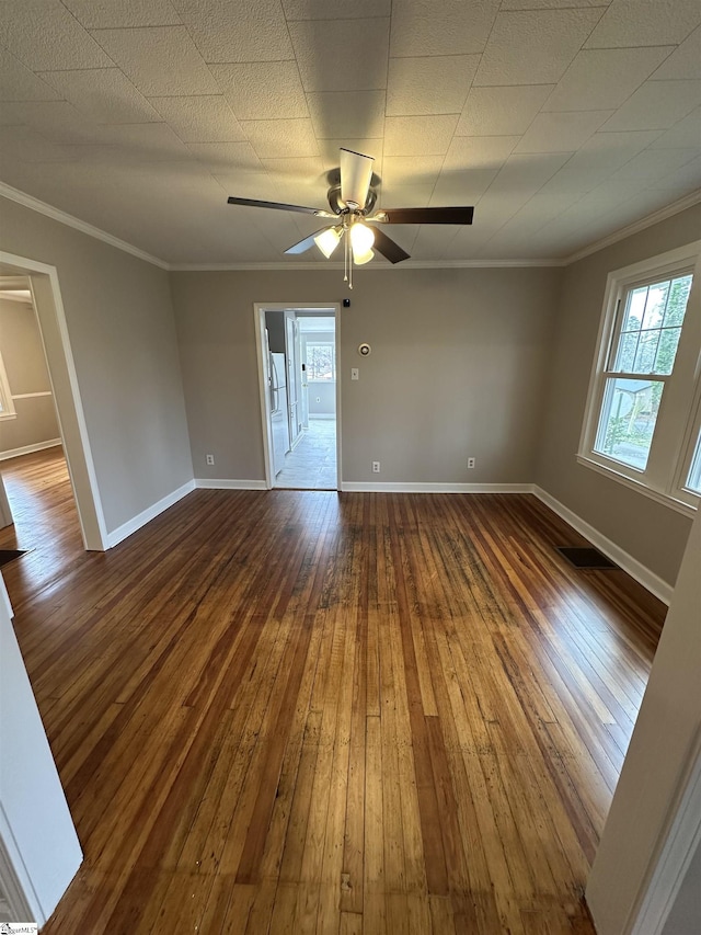 spare room with hardwood / wood-style floors, ornamental molding, and ceiling fan