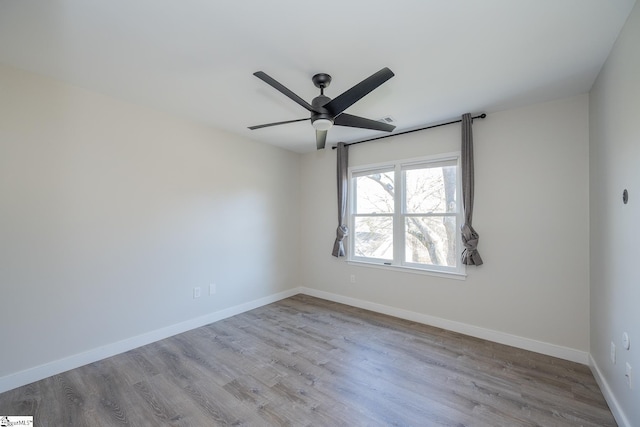 empty room featuring ceiling fan and light hardwood / wood-style flooring