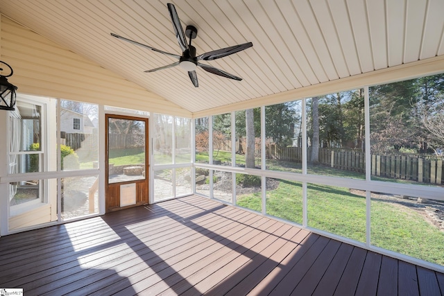 unfurnished sunroom with lofted ceiling, ceiling fan, and a healthy amount of sunlight