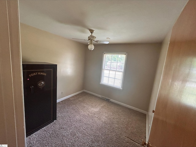 spare room with ceiling fan and carpet