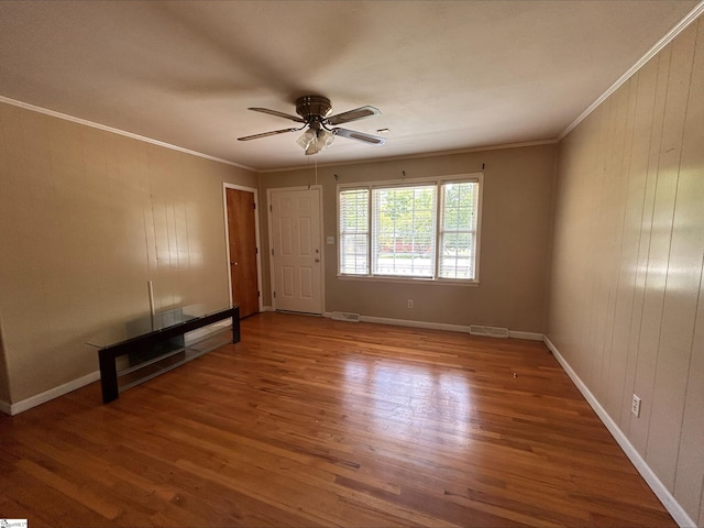 unfurnished living room featuring crown molding, ceiling fan, and hardwood / wood-style flooring