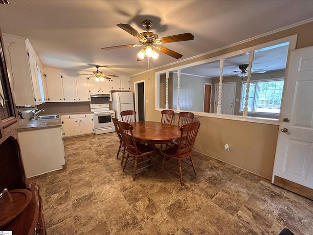 dining room featuring ornamental molding and sink