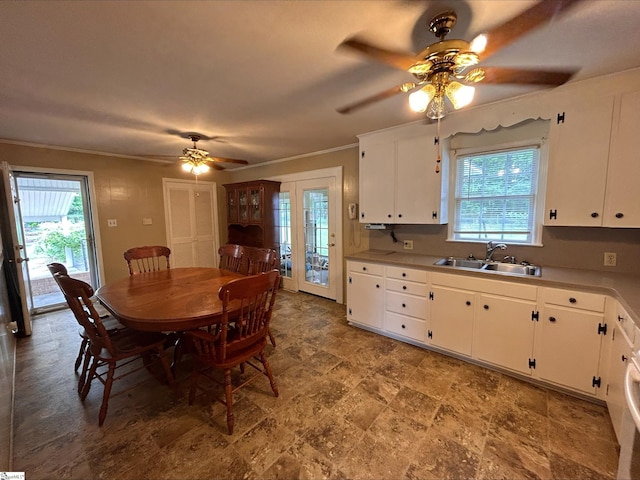 dining space with sink, ornamental molding, and ceiling fan