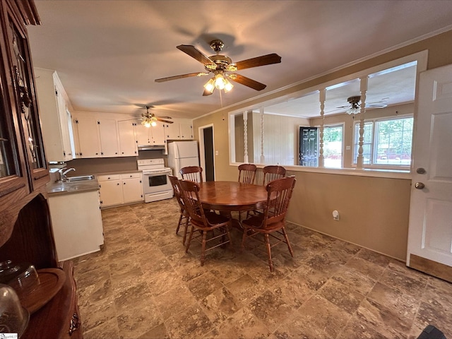 dining room with ornamental molding, sink, and ceiling fan