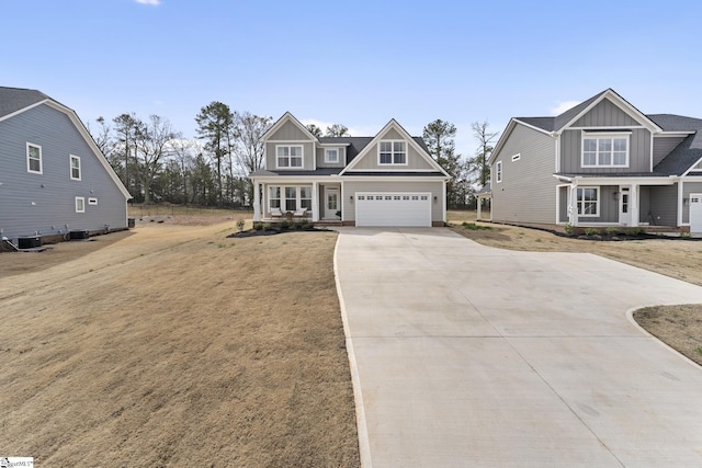 craftsman house featuring central air condition unit, driveway, covered porch, board and batten siding, and a garage