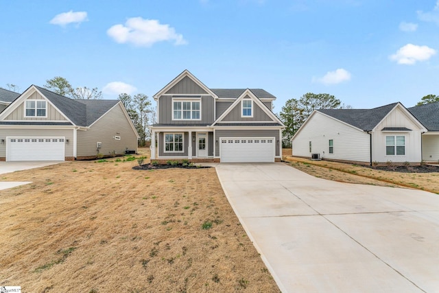 craftsman-style home featuring board and batten siding, central AC, driveway, and a garage