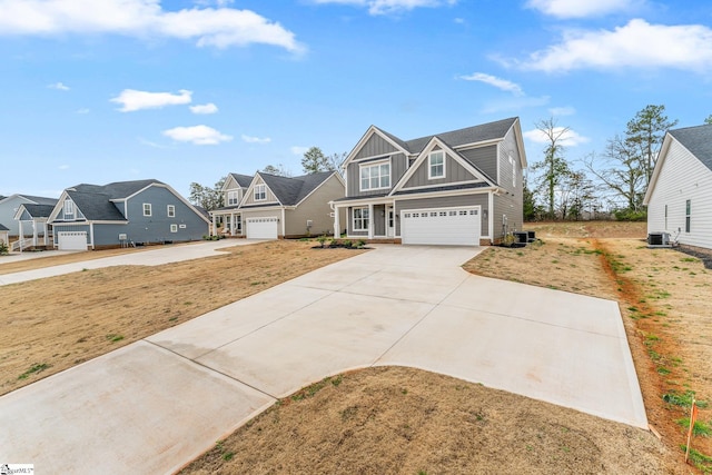 view of front of house featuring board and batten siding, central air condition unit, a residential view, a garage, and driveway