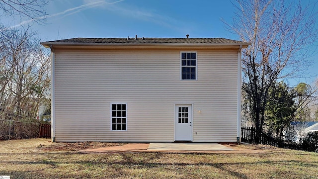 back of house featuring a patio area and a lawn