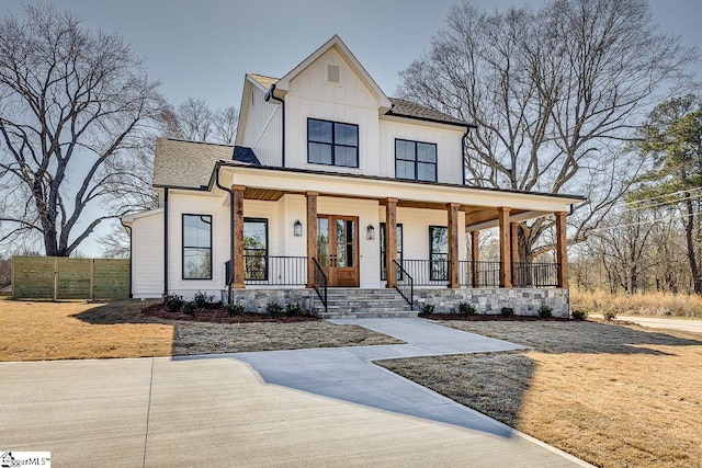 modern farmhouse featuring covered porch and french doors