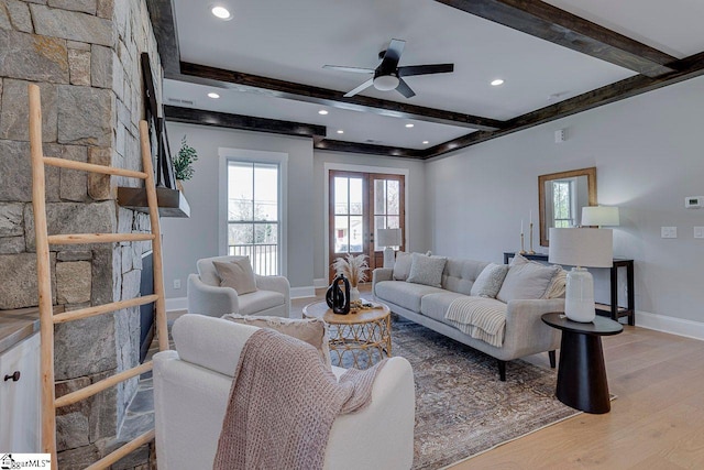 living room with ceiling fan, beam ceiling, and hardwood / wood-style floors