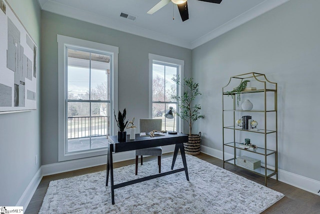 office space featuring dark hardwood / wood-style flooring, ornamental molding, and ceiling fan