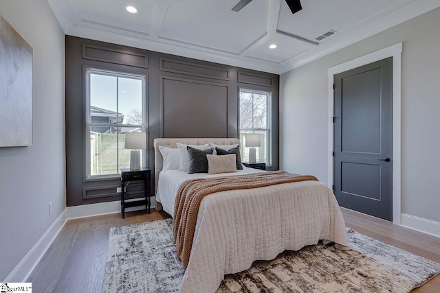 bedroom with ceiling fan, coffered ceiling, hardwood / wood-style floors, and multiple windows