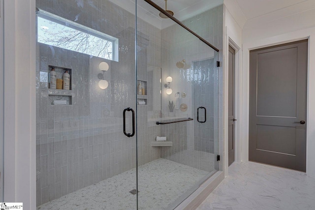 bathroom featuring a shower with door