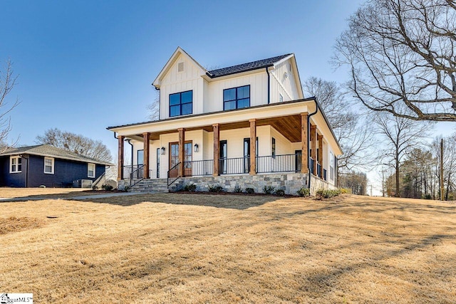 modern inspired farmhouse with a front yard and a porch