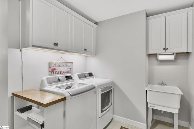 laundry room featuring cabinets and washer and dryer