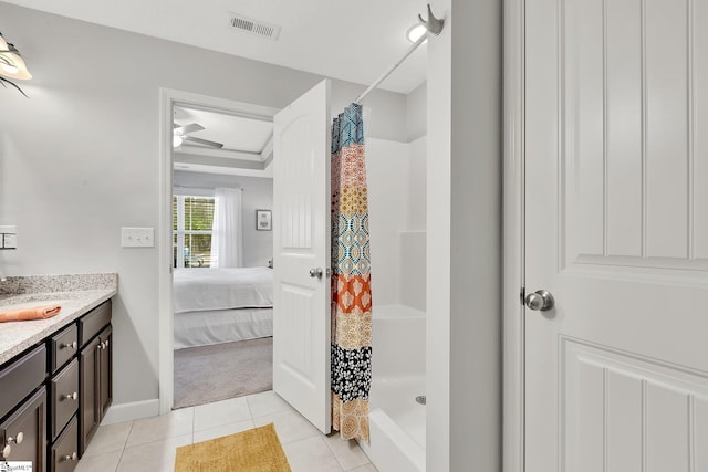 bathroom with vanity, tile patterned floors, and walk in shower