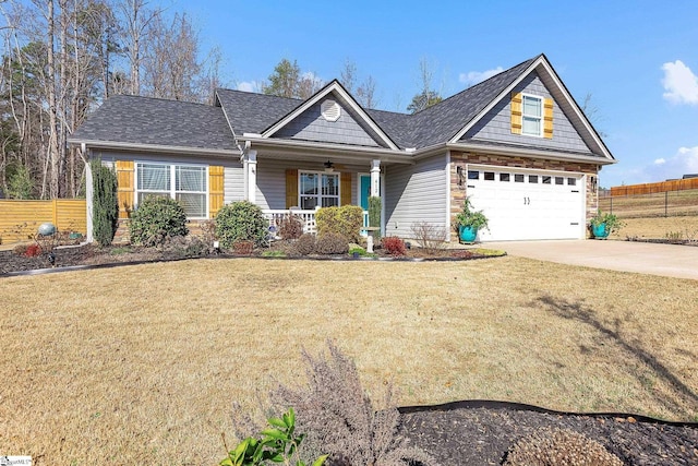 view of front of property with a garage, a porch, and a front yard