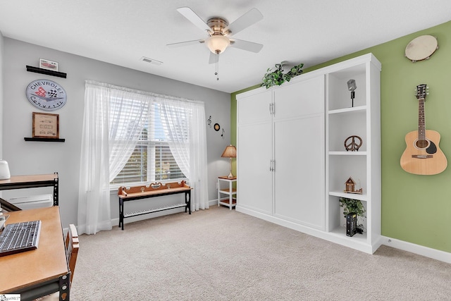 rec room with ceiling fan and light colored carpet