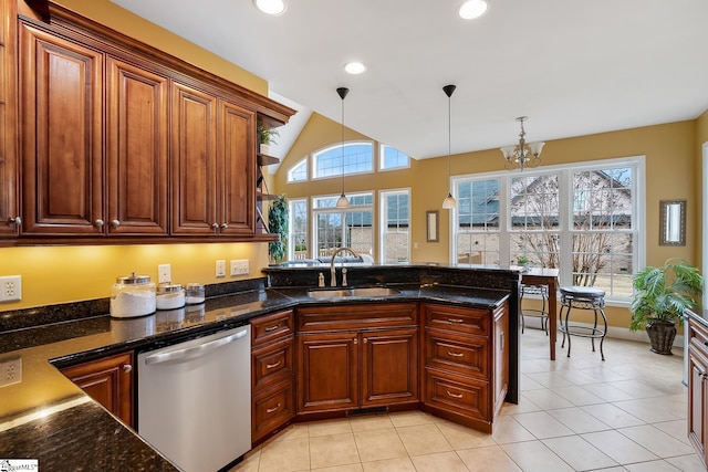 kitchen with vaulted ceiling, sink, hanging light fixtures, stainless steel dishwasher, and light tile patterned floors