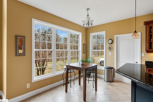 dining space featuring light tile patterned floors and a chandelier