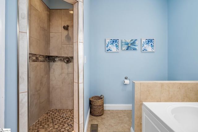 bathroom with tile patterned floors and shower with separate bathtub