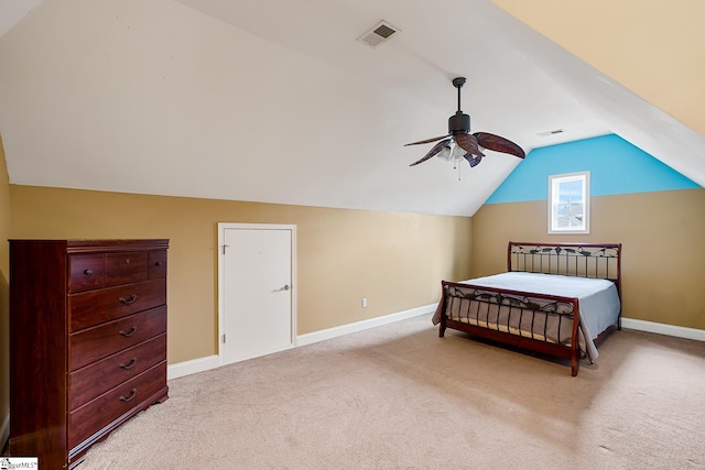 bedroom with ceiling fan, light colored carpet, and vaulted ceiling