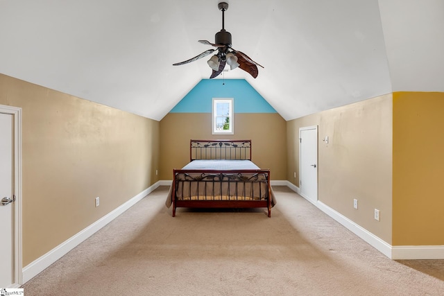 carpeted bedroom with vaulted ceiling and ceiling fan