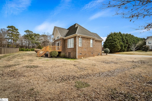 view of property exterior featuring a wooden deck and a lawn