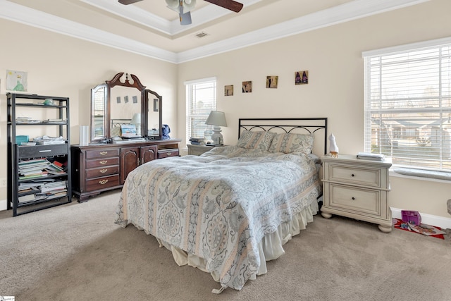 carpeted bedroom featuring crown molding, ceiling fan, and a tray ceiling