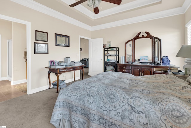 carpeted bedroom with crown molding, ceiling fan, and a raised ceiling