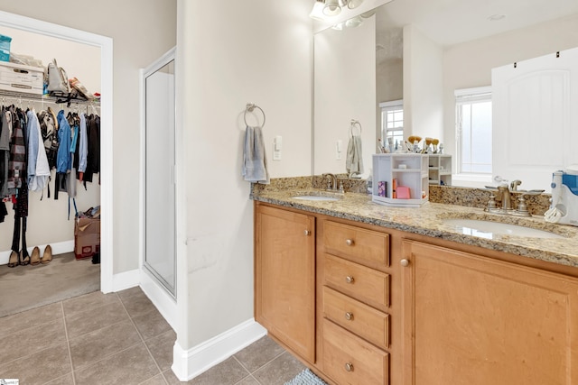 bathroom with walk in shower, tile patterned floors, and vanity