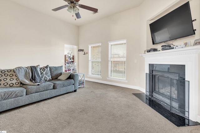 carpeted living room with ceiling fan