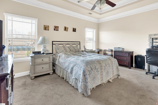 carpeted bedroom with crown molding, ceiling fan, and a tray ceiling