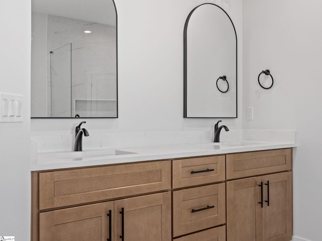 bathroom with walk in shower and vanity