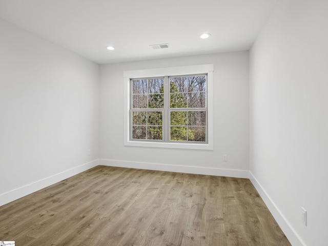 spare room featuring light hardwood / wood-style floors