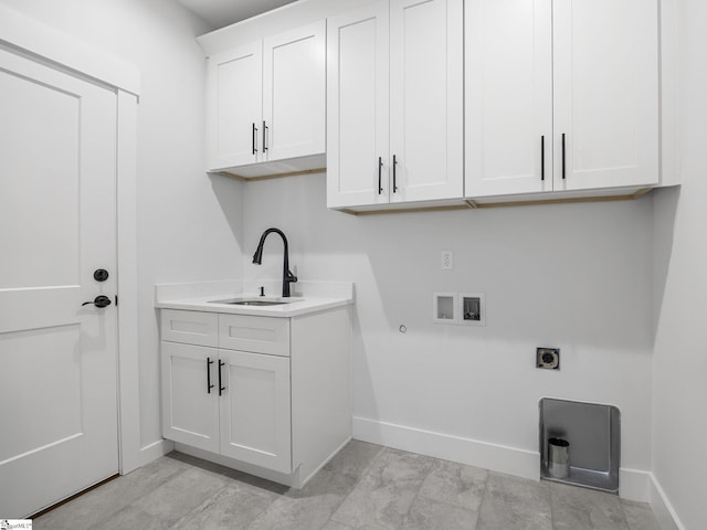 laundry area featuring gas dryer hookup, sink, cabinets, washer hookup, and hookup for an electric dryer