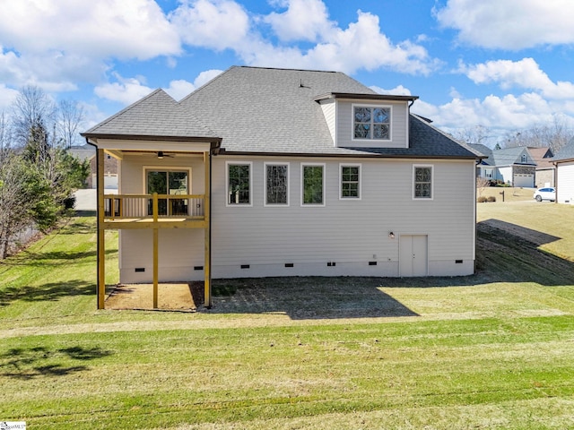 back of property featuring ceiling fan and a lawn