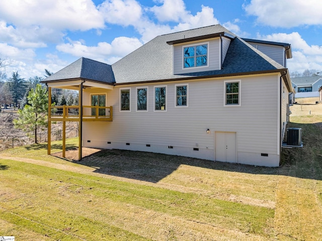 back of house with cooling unit, ceiling fan, and a lawn