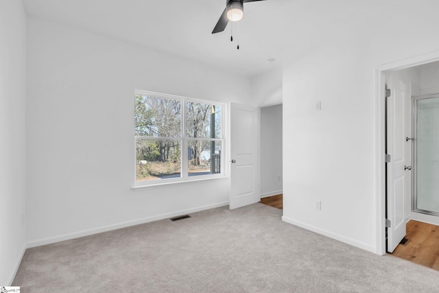 unfurnished bedroom with ceiling fan and light carpet