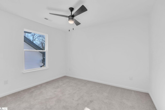 empty room with light colored carpet and ceiling fan