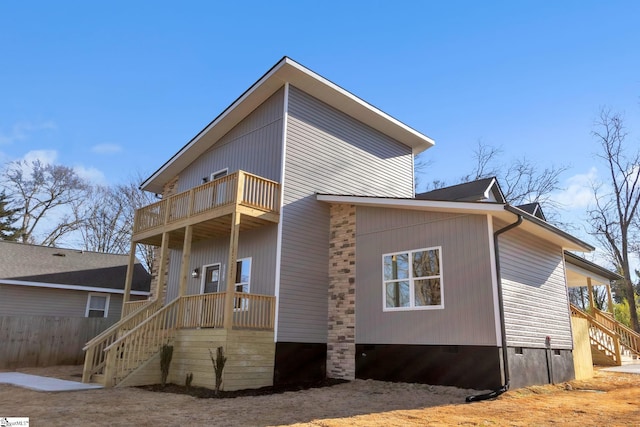 rear view of property featuring a balcony